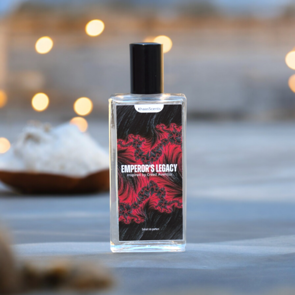 A Perfume named "Emperor Legacy" is placed on the sand at beach with background of Sea and lights