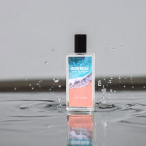 A Perfume named "Ocean Breeze" is placed on the beach with the background of Sea